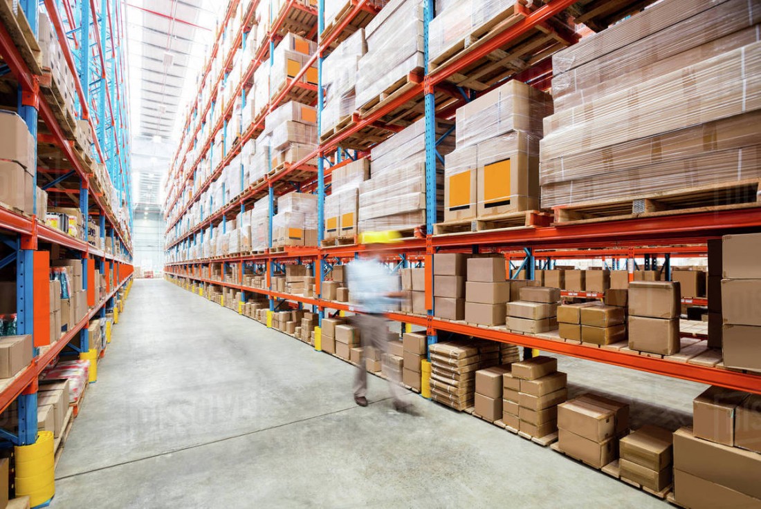 Inside of a hardware store aisle filled with boxes of product